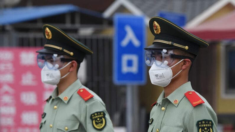 지난 2020년 6월 13일 베이징 신파디 시장이 중공 바이러스 집단발병으로 폐쇄된 가운데 시장 입구에서 무장경찰이 마스크와 보안경을 착용하고 경비를 서고 있다. | GREG BAKER/AFP via Getty Images