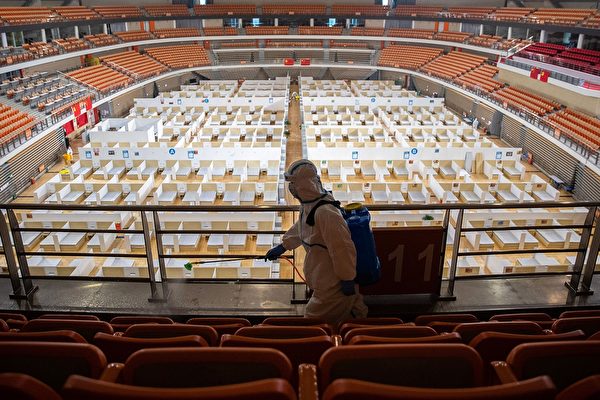 우한의 종합 체육관 내에 설치된 임시병원을 소독하고 있는 방역 요원. 2020.3.8 | STR/AFP via Getty Images