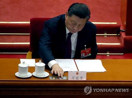 시진핑 중국 국가주석이 11일 중국 베이징 전인대 회의장에서 투표 버튼을 누르는 모습. | UPI=연합뉴스