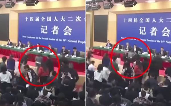 중국 제14기 전인대 둘째날이었던 지난 6일 기자회견에서 한 여기자가 연단으로 돌진하다가 저지된 사건이 뒤늦게 알려졌다. | 싼리TV 화면 캡처