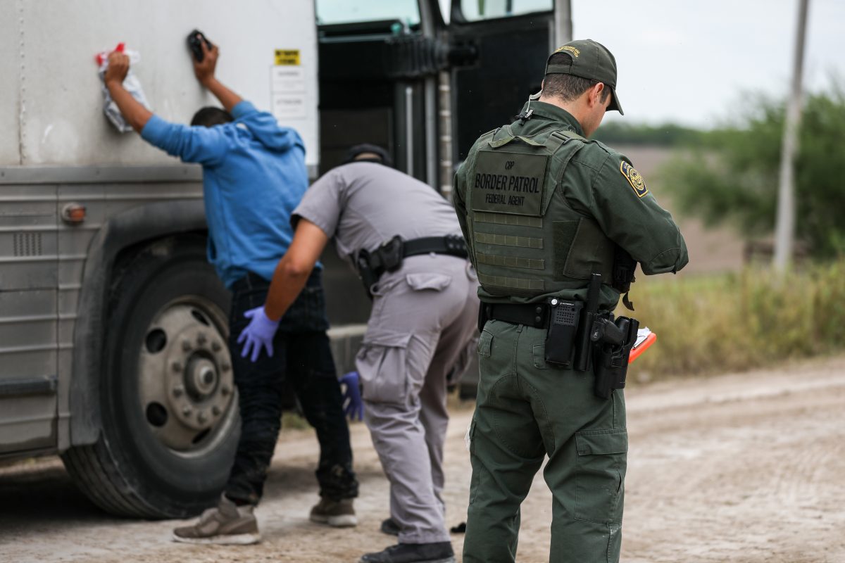 Border Patrol agents apprehend illegal aliens who have just crossed the Rio Grande from Mexico into Penitas