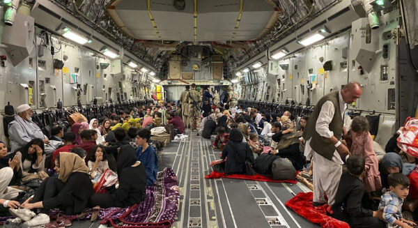 Afghan people sit inside a U S military aircraft